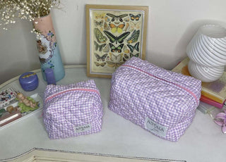 Astala Luna Euphoria Mini purple gingham quilted bag displayed beside a larger matching bag on a vintage table.